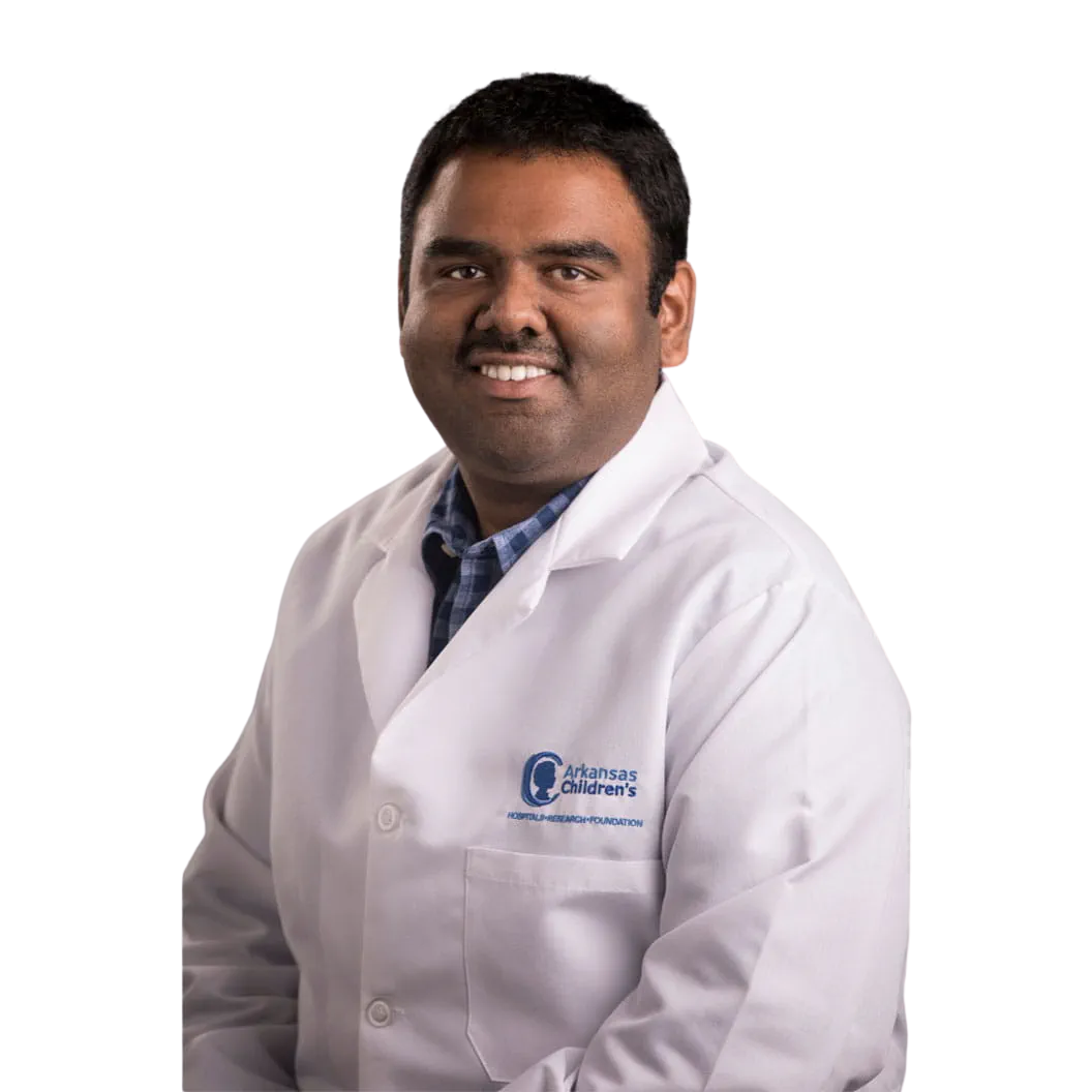 Portrait Of Mature Male Doctor Wearing White Coat Standing In Hospital Corridor