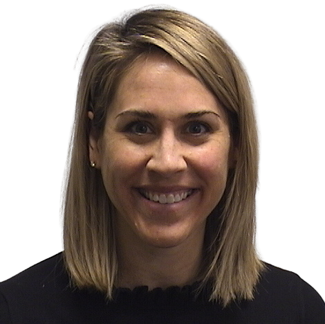 Portrait Of Mature Male Doctor Wearing White Coat Standing In Hospital Corridor