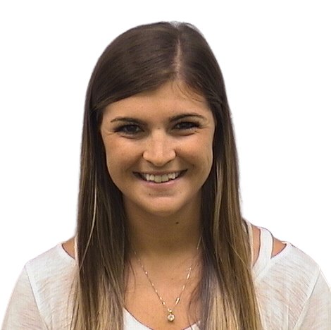 Portrait Of Mature Male Doctor Wearing White Coat Standing In Hospital Corridor