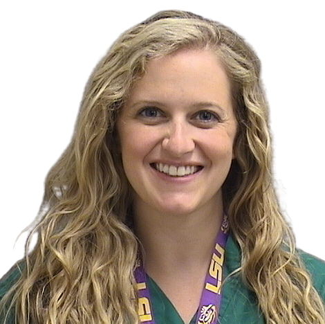 Portrait Of Mature Male Doctor Wearing White Coat Standing In Hospital Corridor