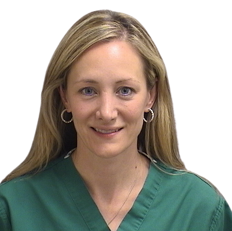 Portrait Of Mature Male Doctor Wearing White Coat Standing In Hospital Corridor