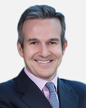 photo of Pablo Berckholtz wearing dark suit with multi coloured tie