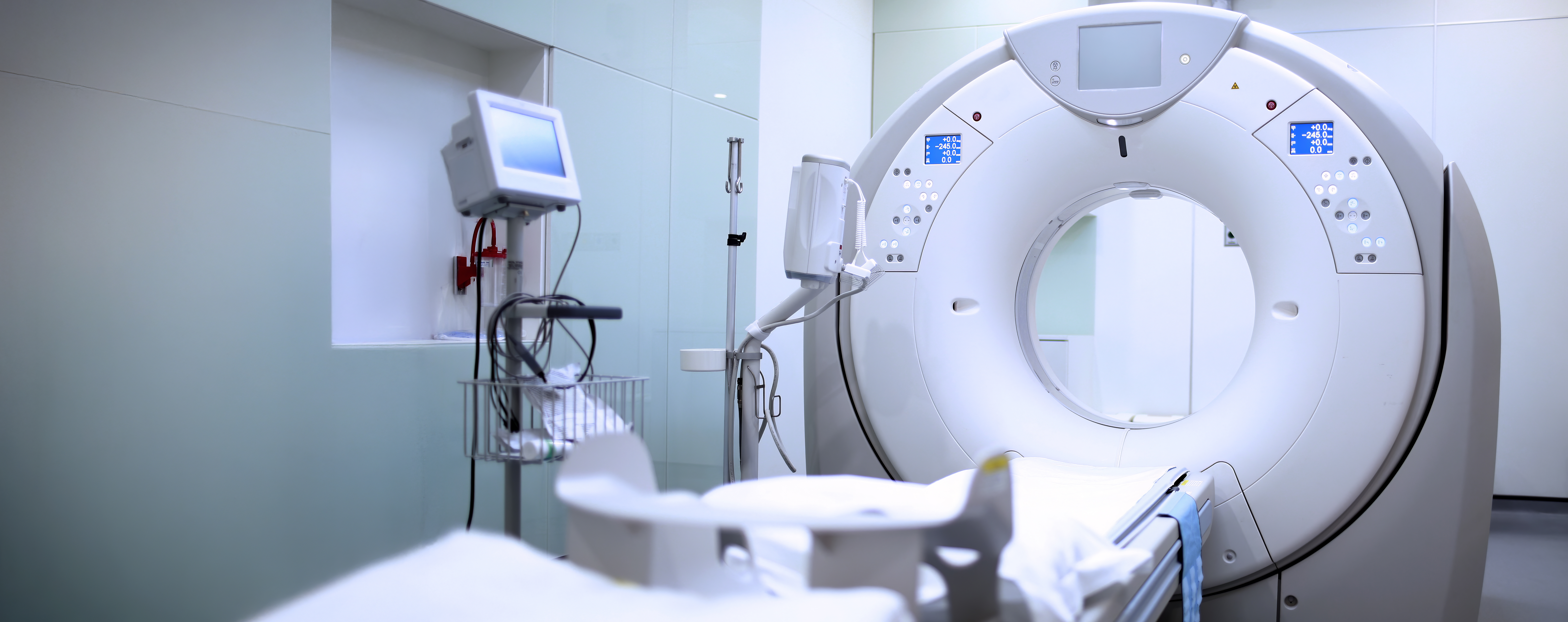 set of hands using laptop with sun glare in the background, modern office