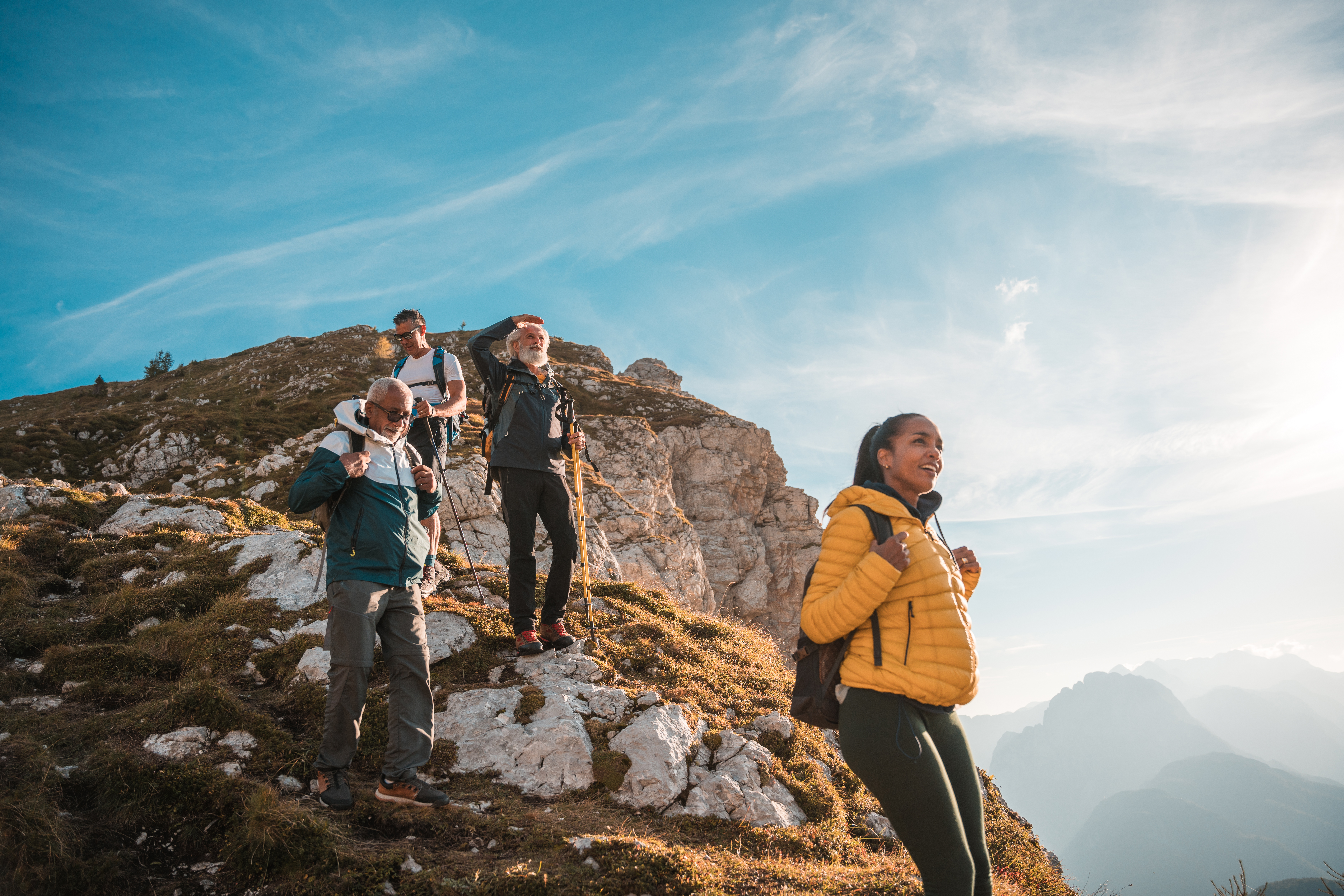 Group of people hiking against a backdrop of mountains
