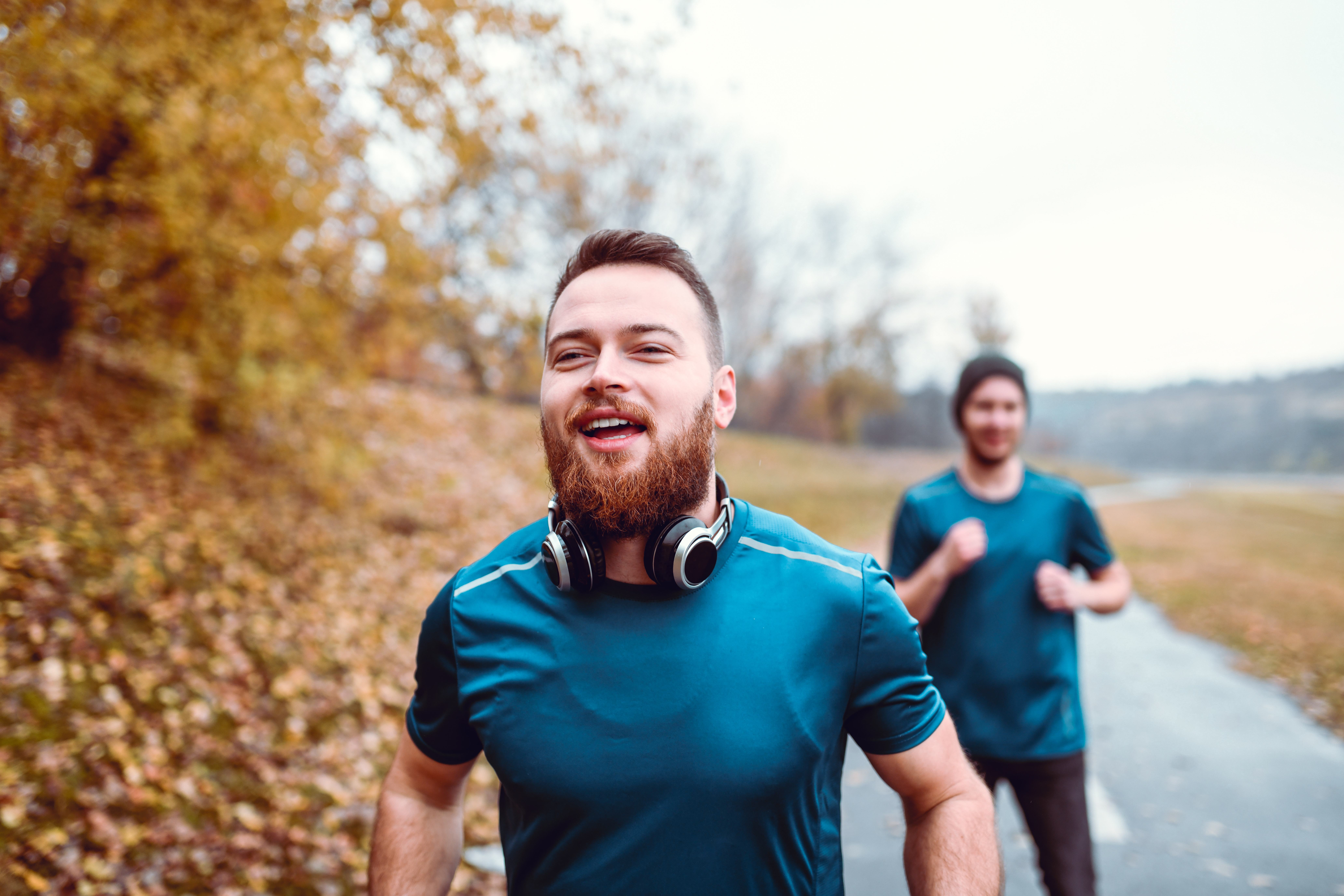 Men running in a park during winter