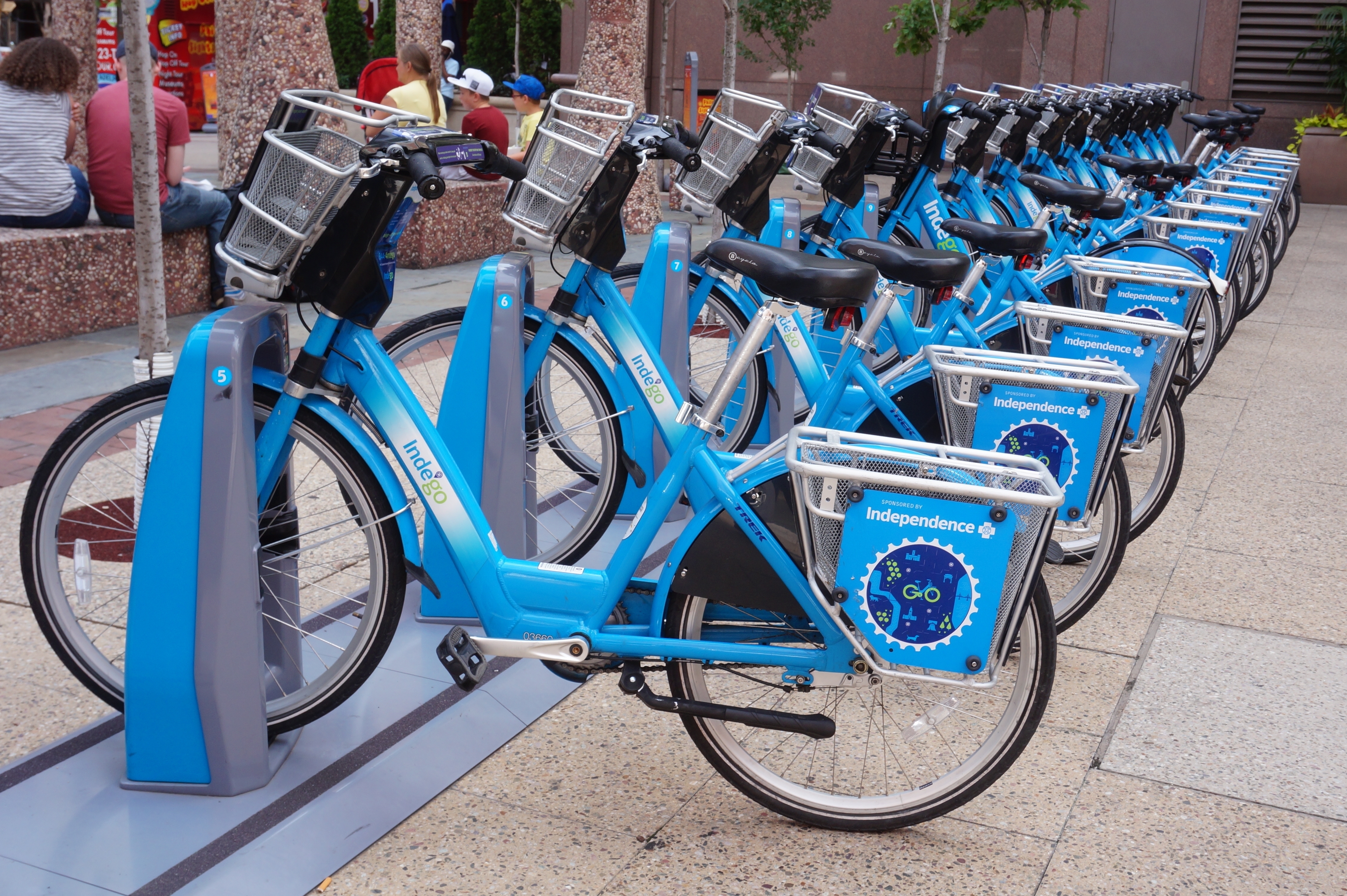 Mature african american coach explaining strategy to his team with copy space. Successful businessman presenting new project to employees during meeting room. Conference speaker talk to audience while giving presentation on whiteboard to business group of people.