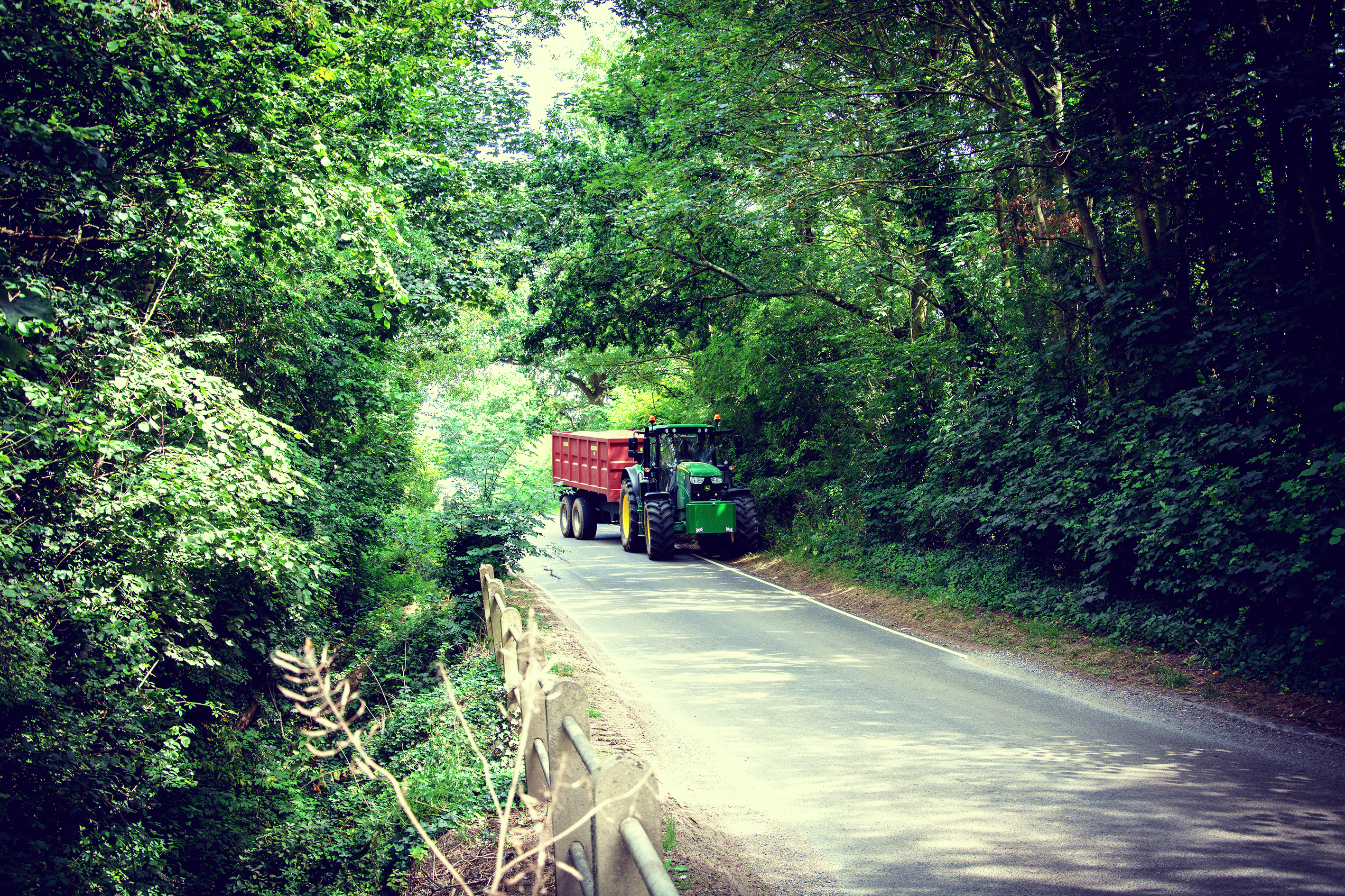 image of tractor driving down a country road