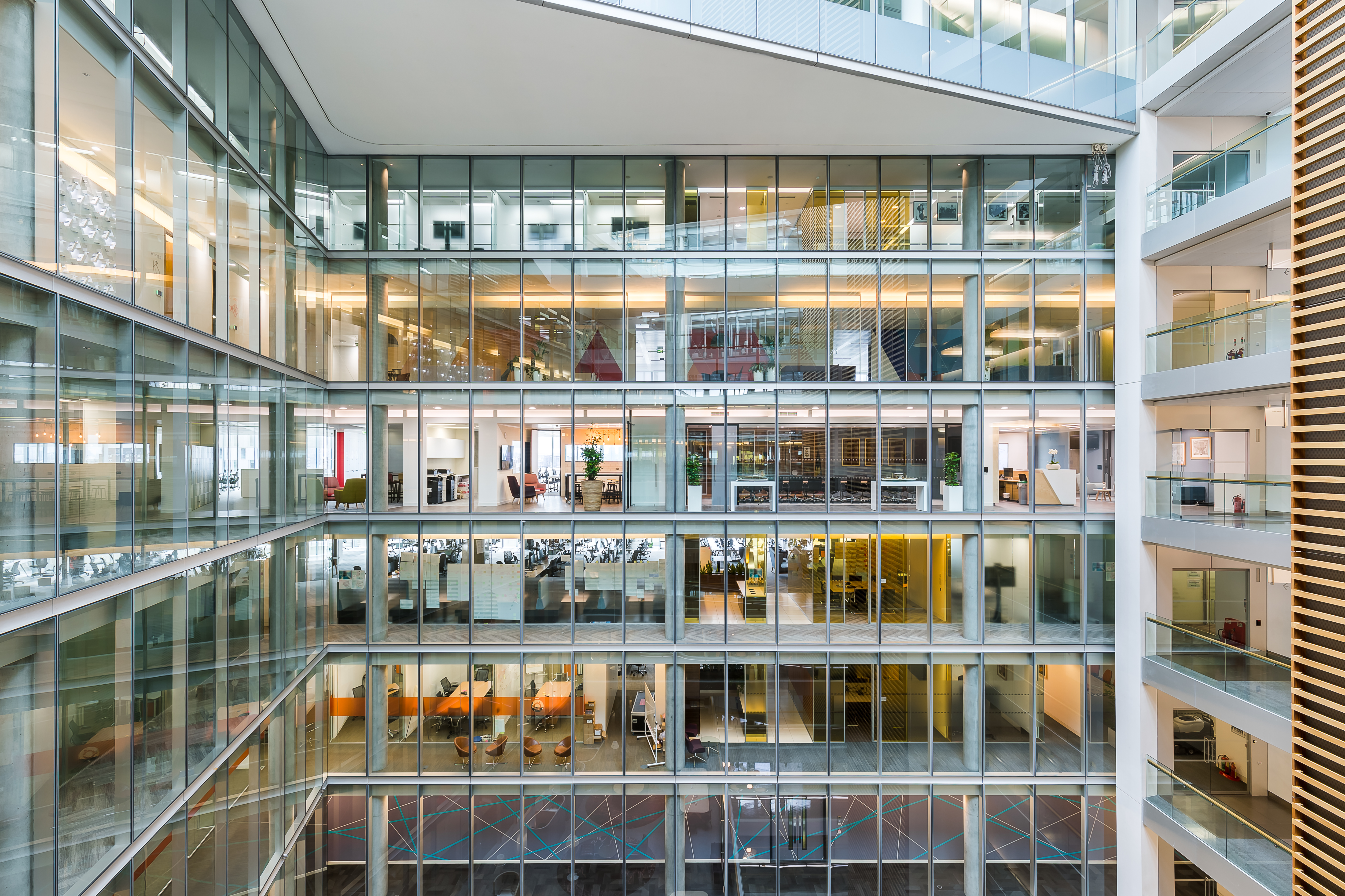Background image of laptop on wooden table in modern office interior, workplace design concept, copy space