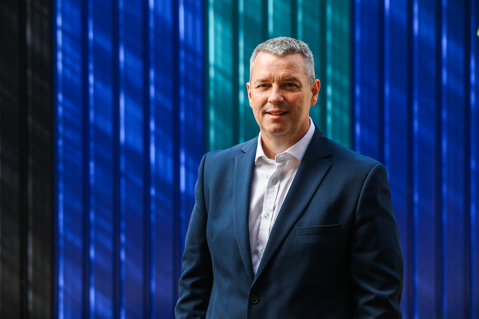 A picture of Lee Richards, Head of Carter Jonas' BTR & PRS teams stood outside of a striped facade at Wimbledon Football ground