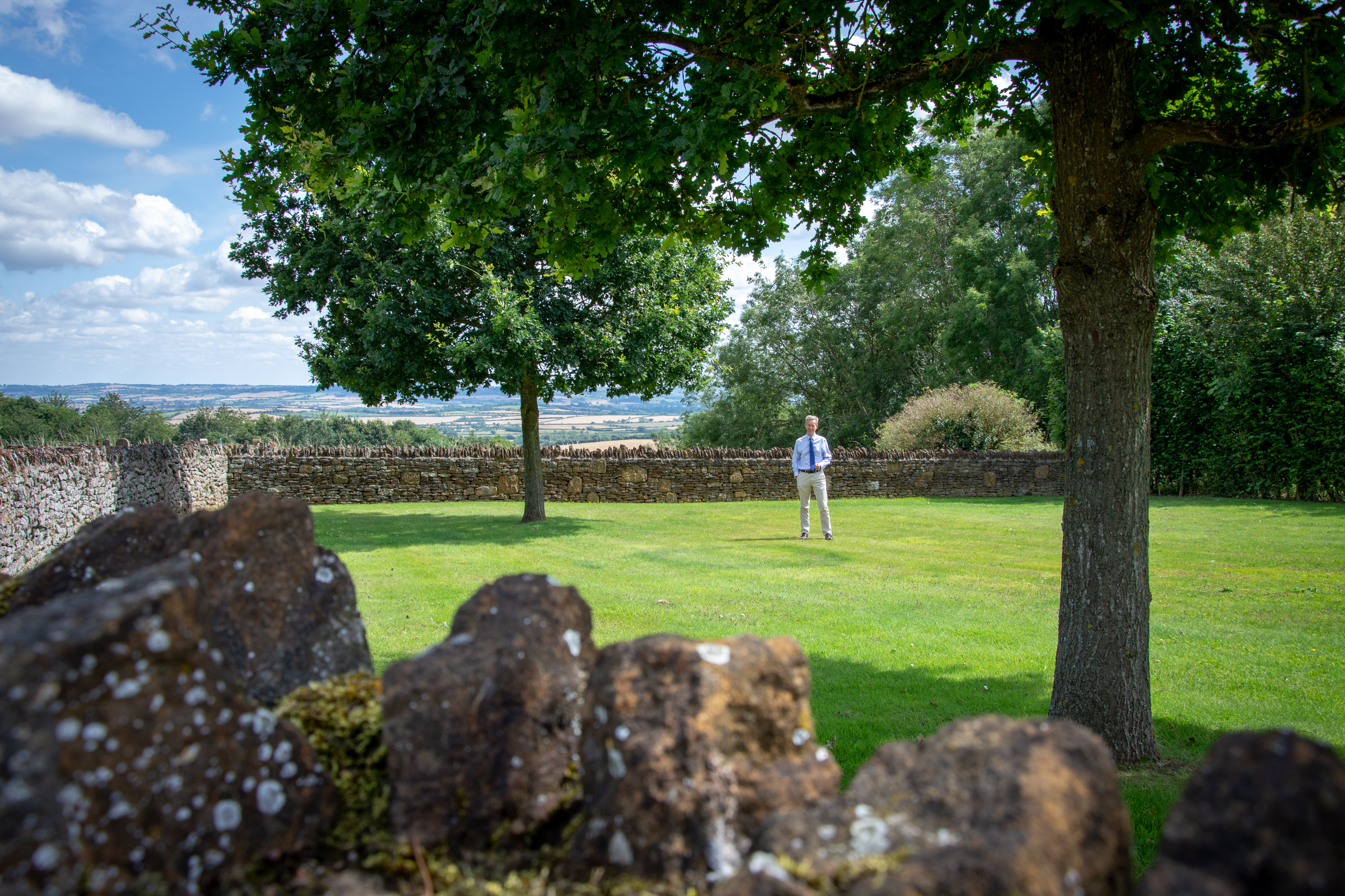 Surveyor doing road survey using modern robotic total station EDM before begining of construction works and setting construction site