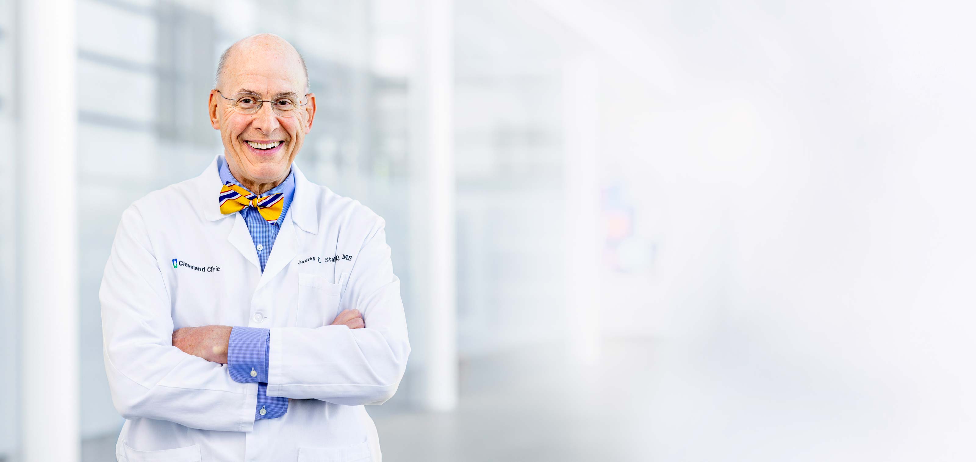 Female caregiver smiling at patient bedside
