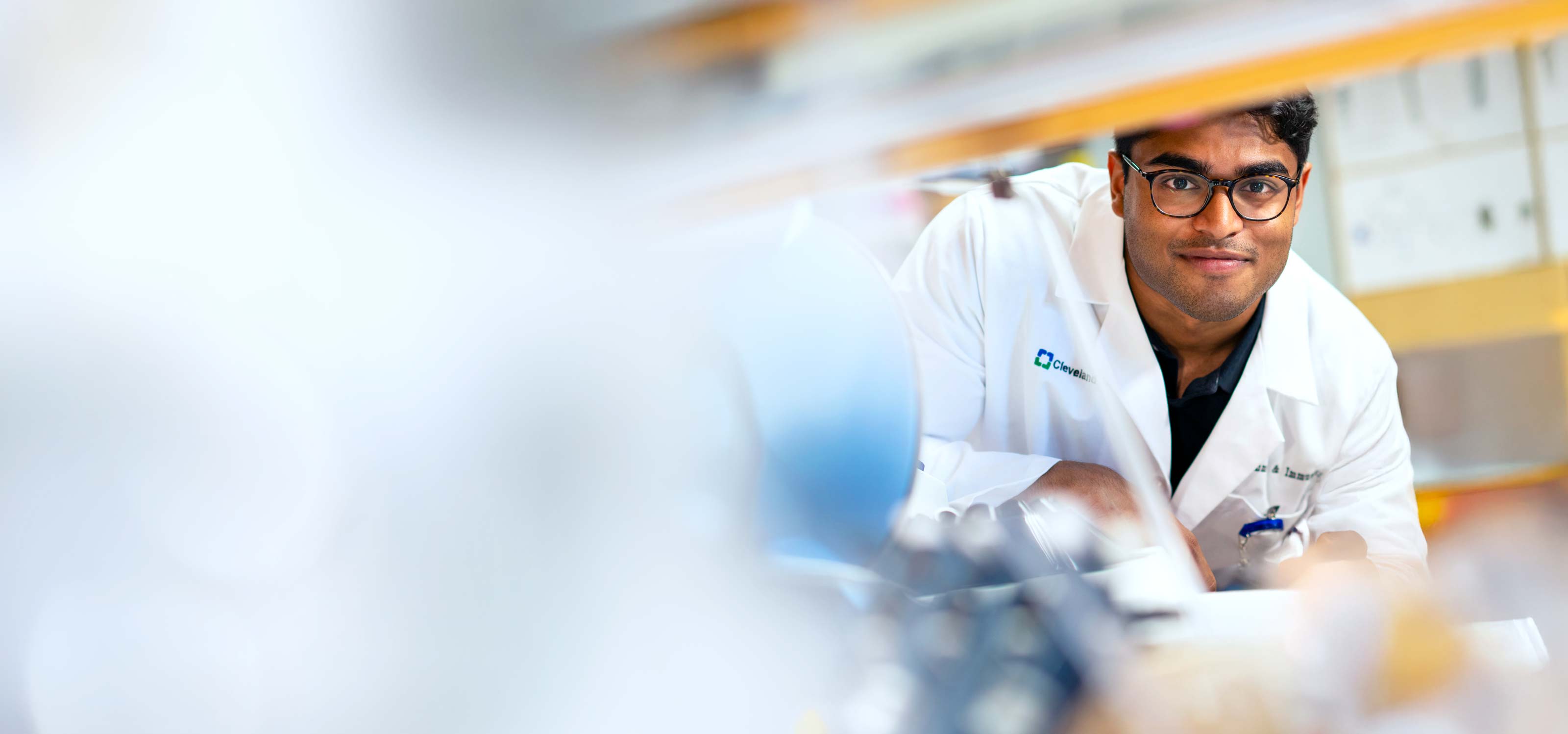 Female caregiver smiling at patient bedside
