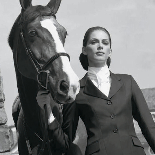 woman standing next to a horse.