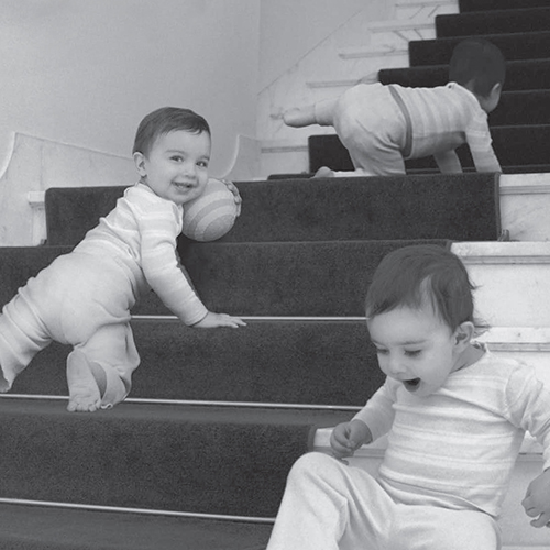babies smiling and crawling on stairs