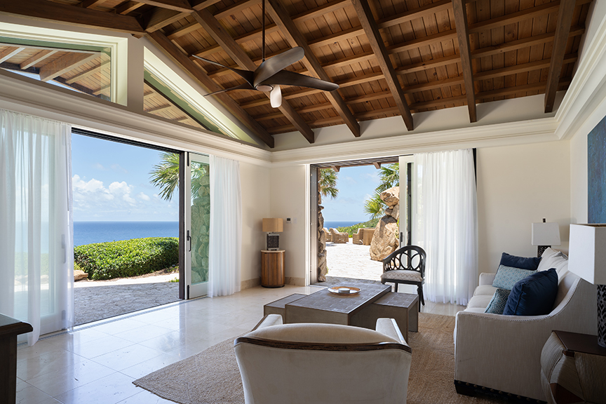 Modern living room with ocean view and patio access.