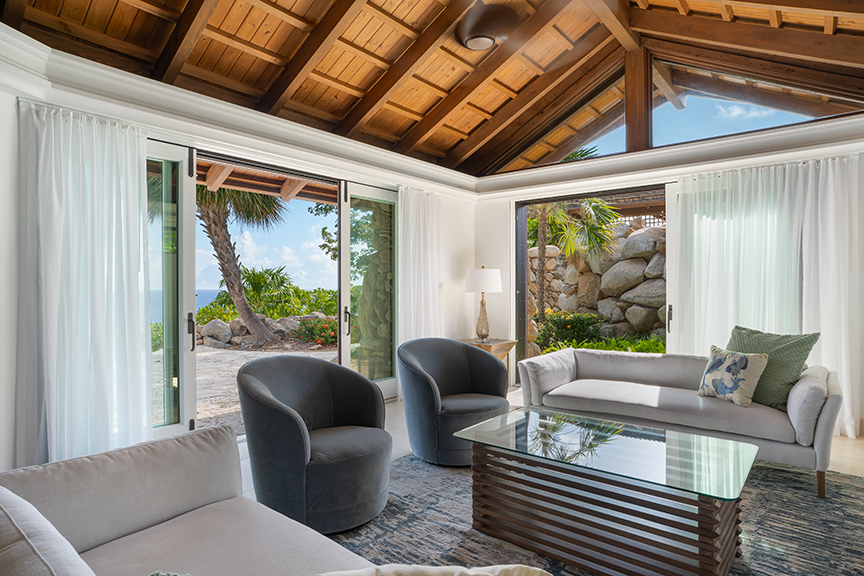 Modern living room with large windows and outdoor view.