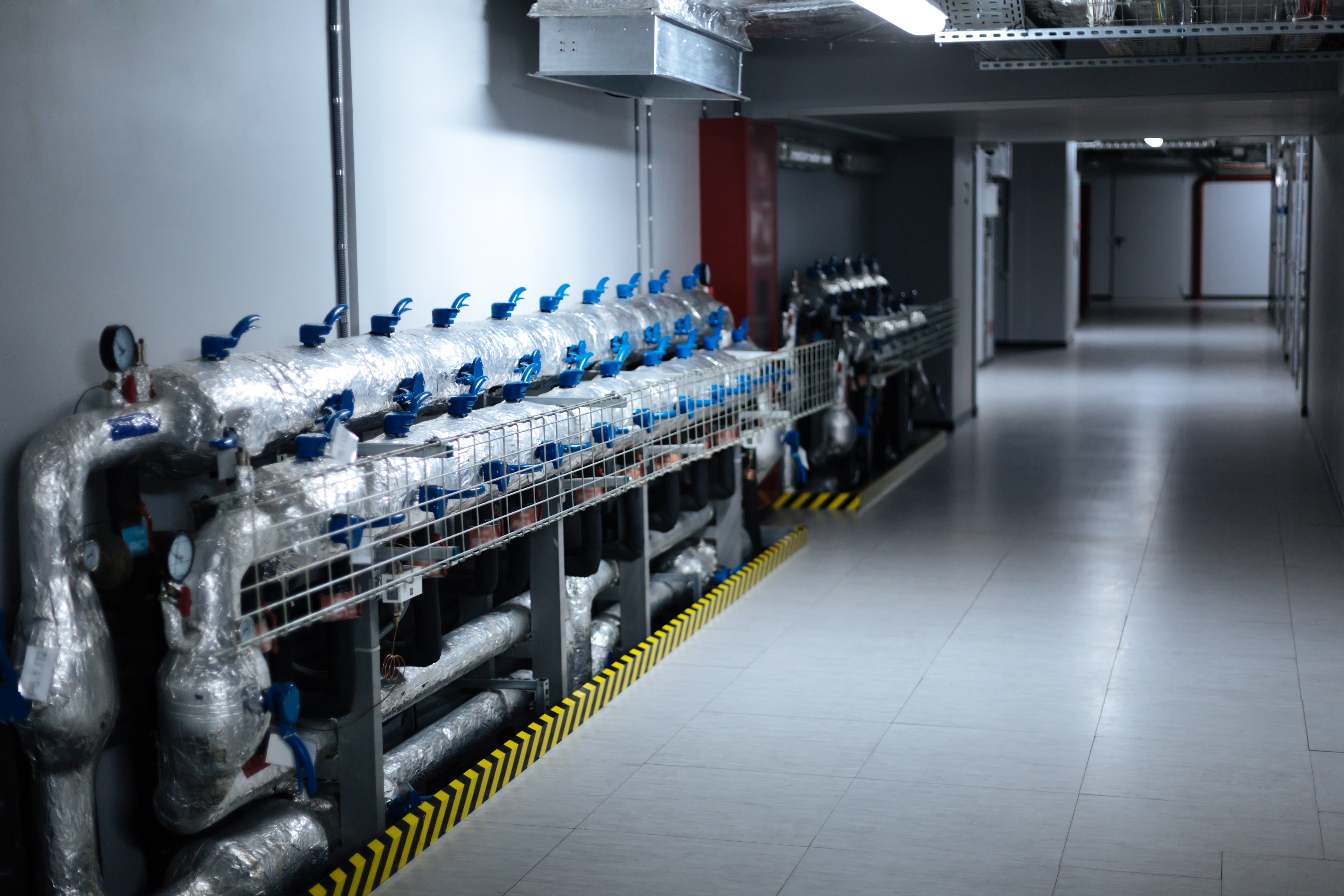 Technical room. Close up of modern pipes standing near the wall in the data center building