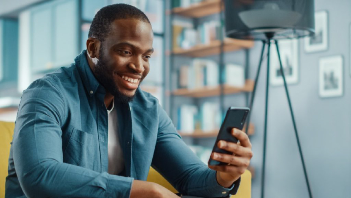Man at home using mobile phone