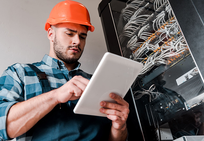 Field Service Technician checking wires