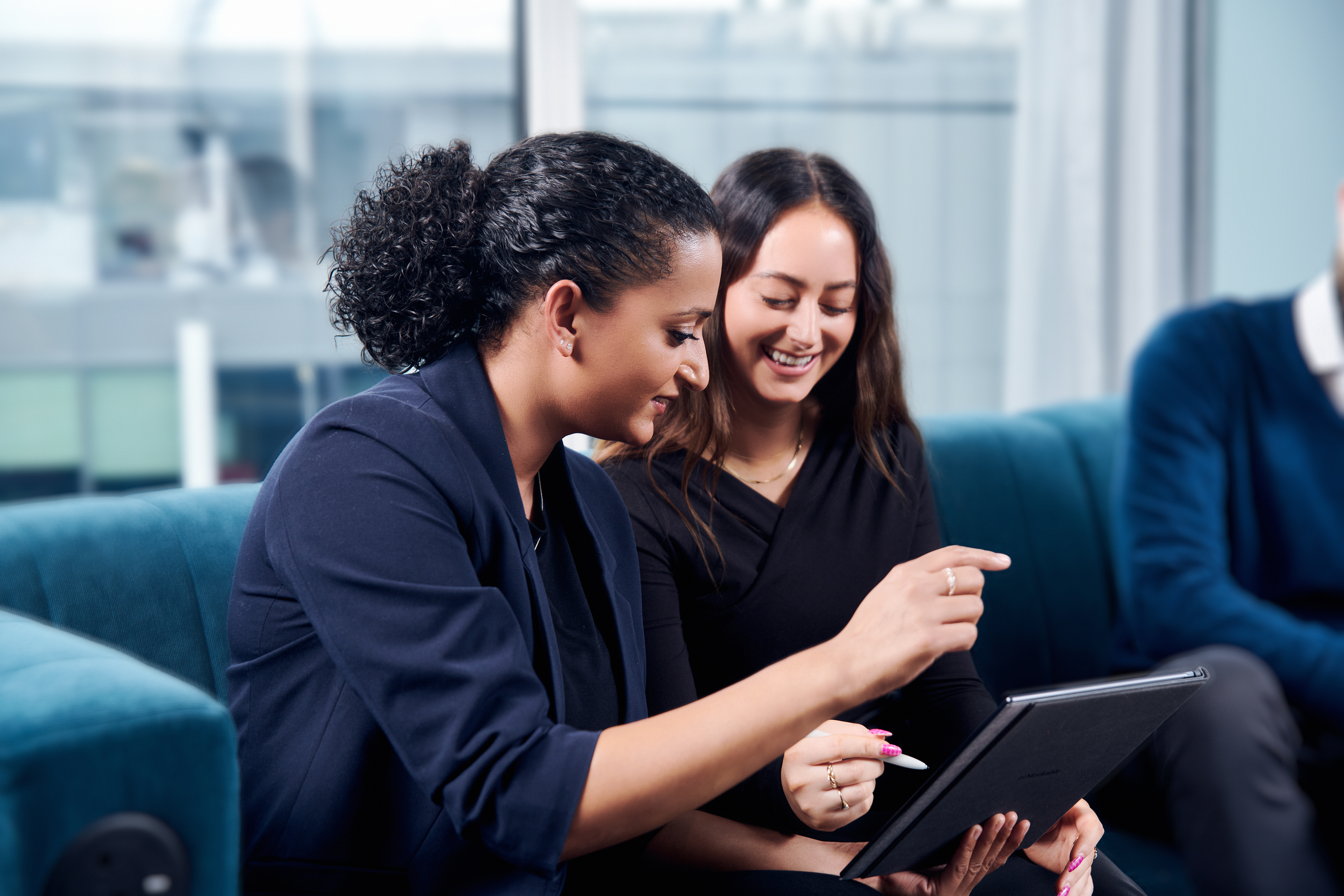 Two women working on a tablet