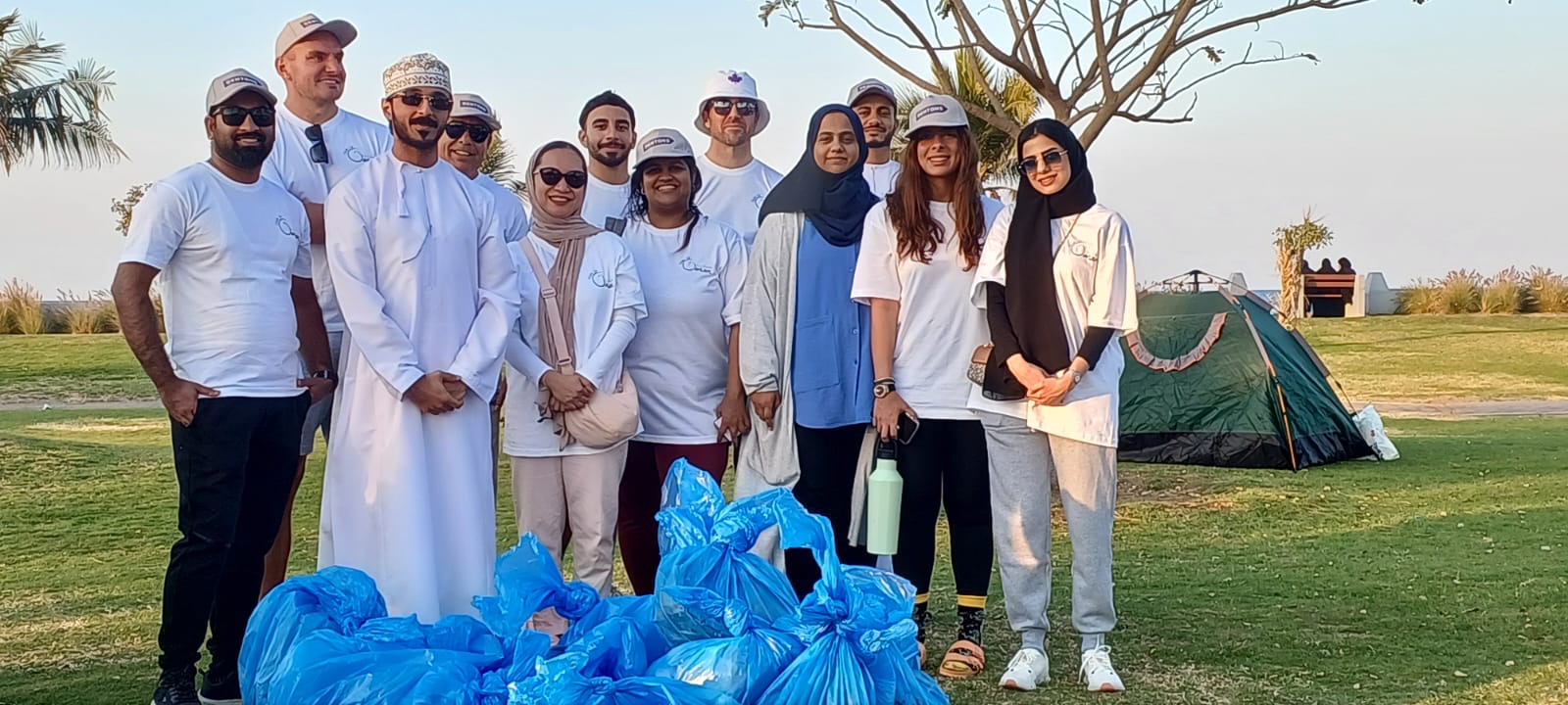 Team of volunteers beach cleaning in Oman