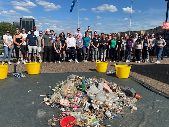 The full group. of volunteers at London dock lands on a sunny day