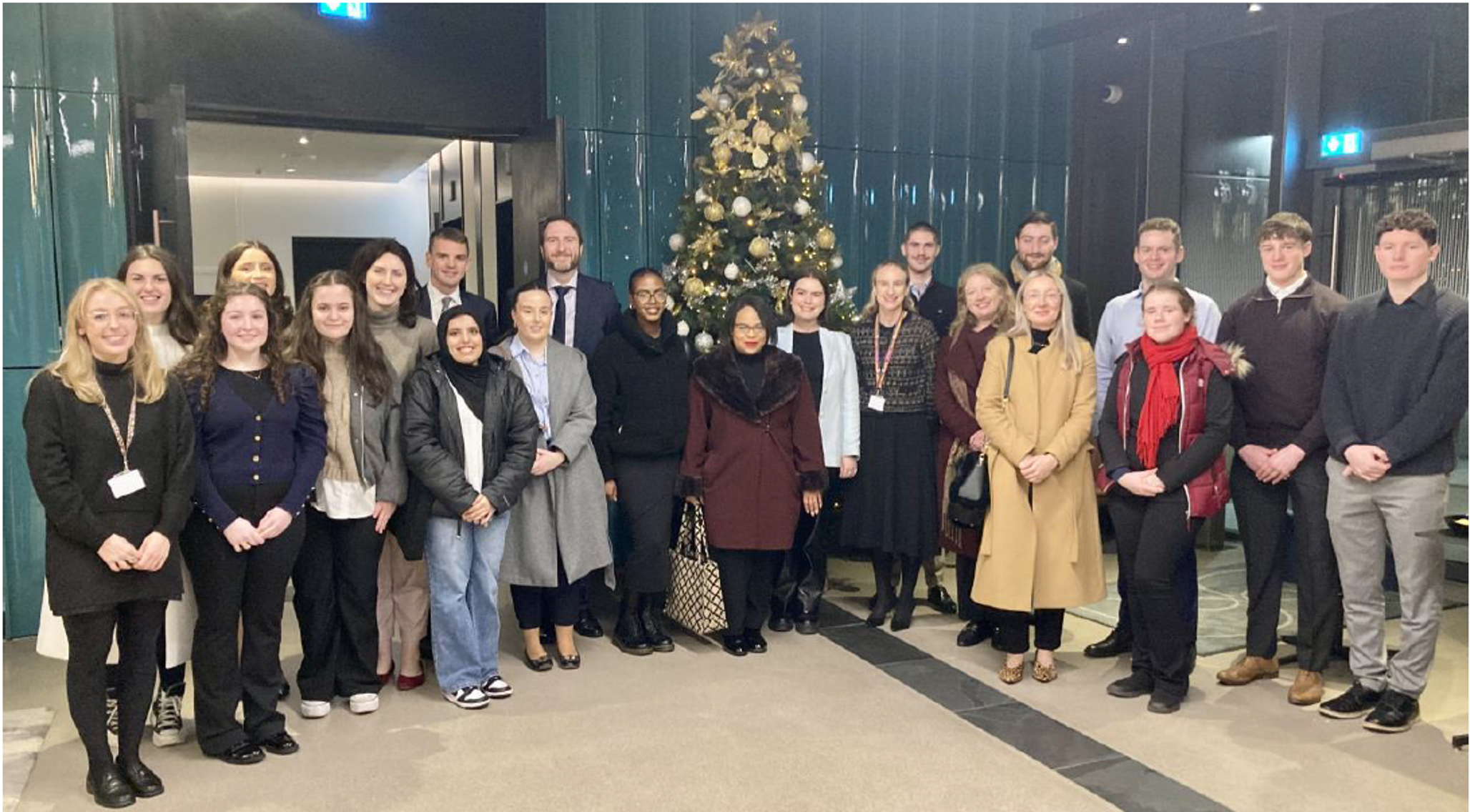 Mentoring group at Maynooth University standing in front of a Christmas tree