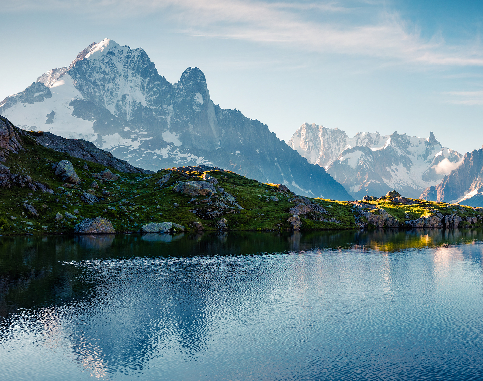 Blue lake in rugged mountain terrain.