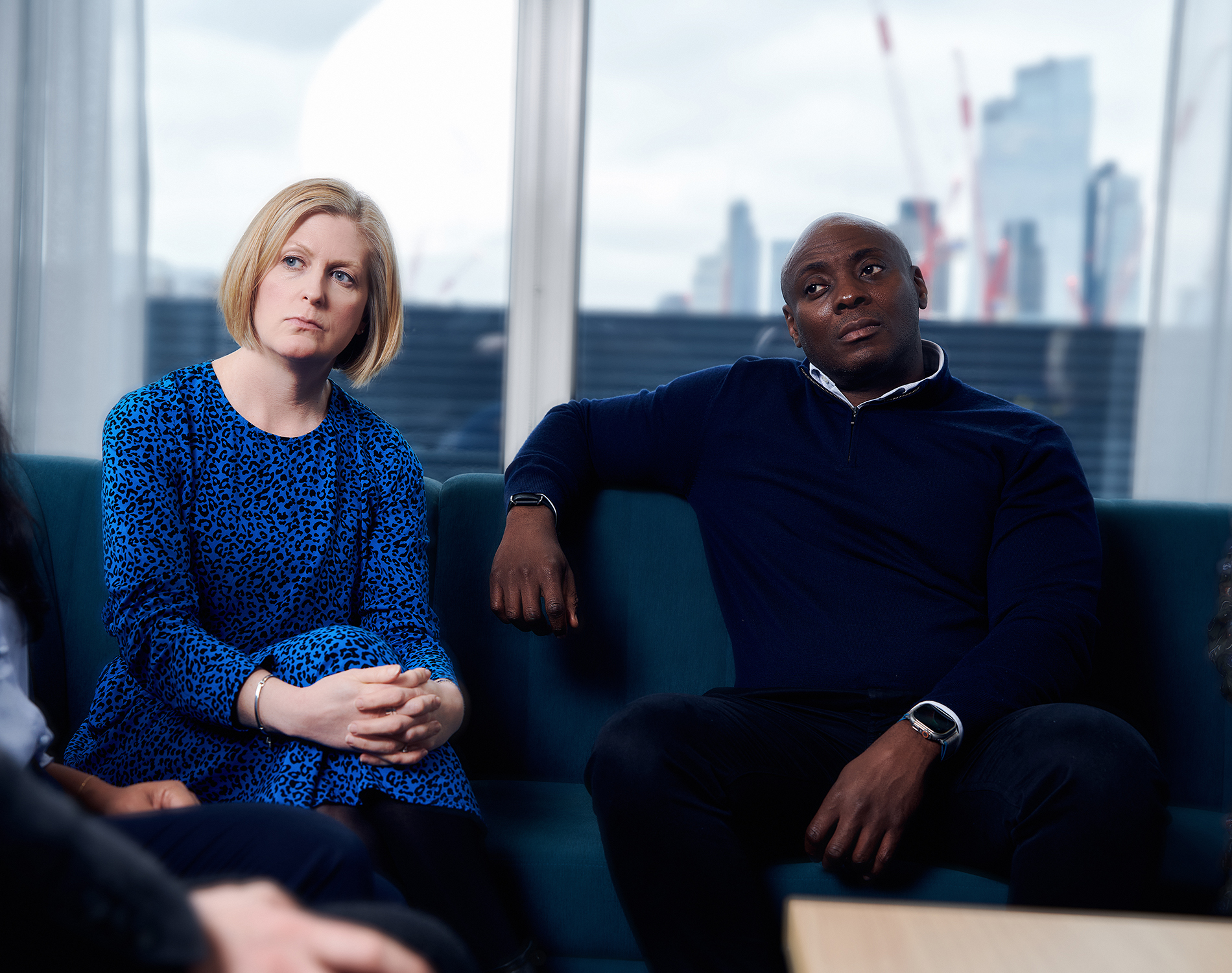 Two colleagues listening intently in a meeting.