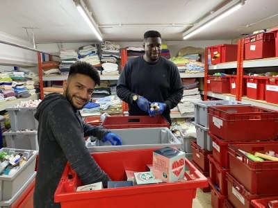 Two colleagues volunteering at a Whitechapel foodbank.
