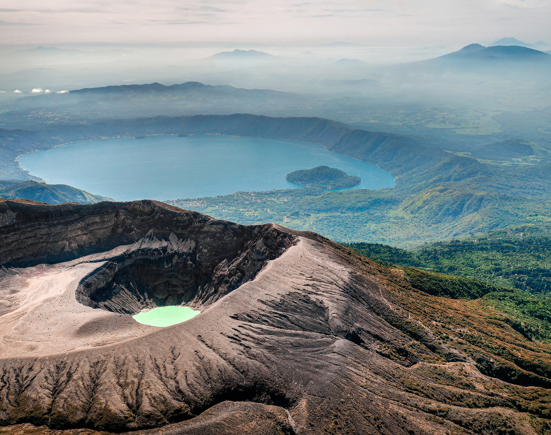 Volcanic lake looking over the forest and a large body of water