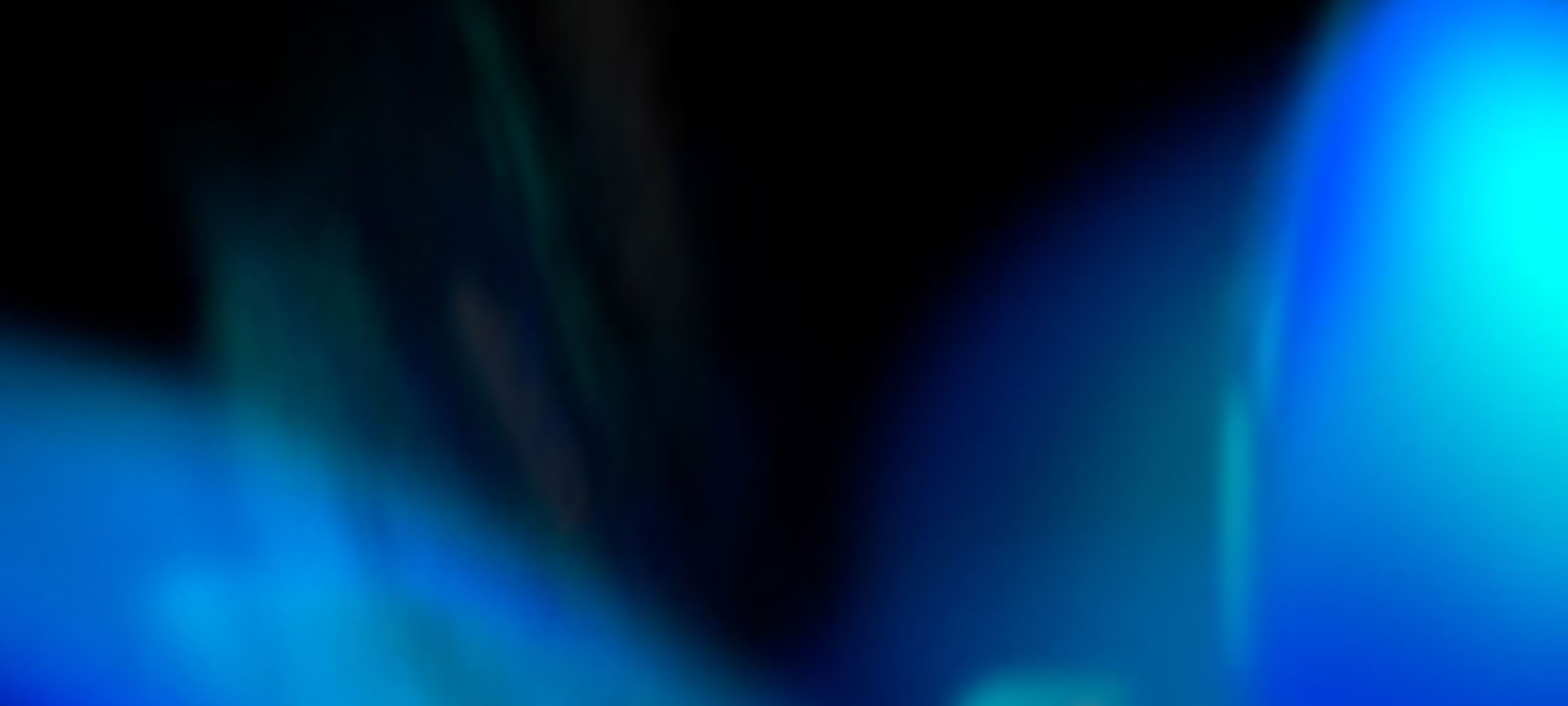 Image of an abstract, ethereal shape with blue and cyan hues set against a black background.
