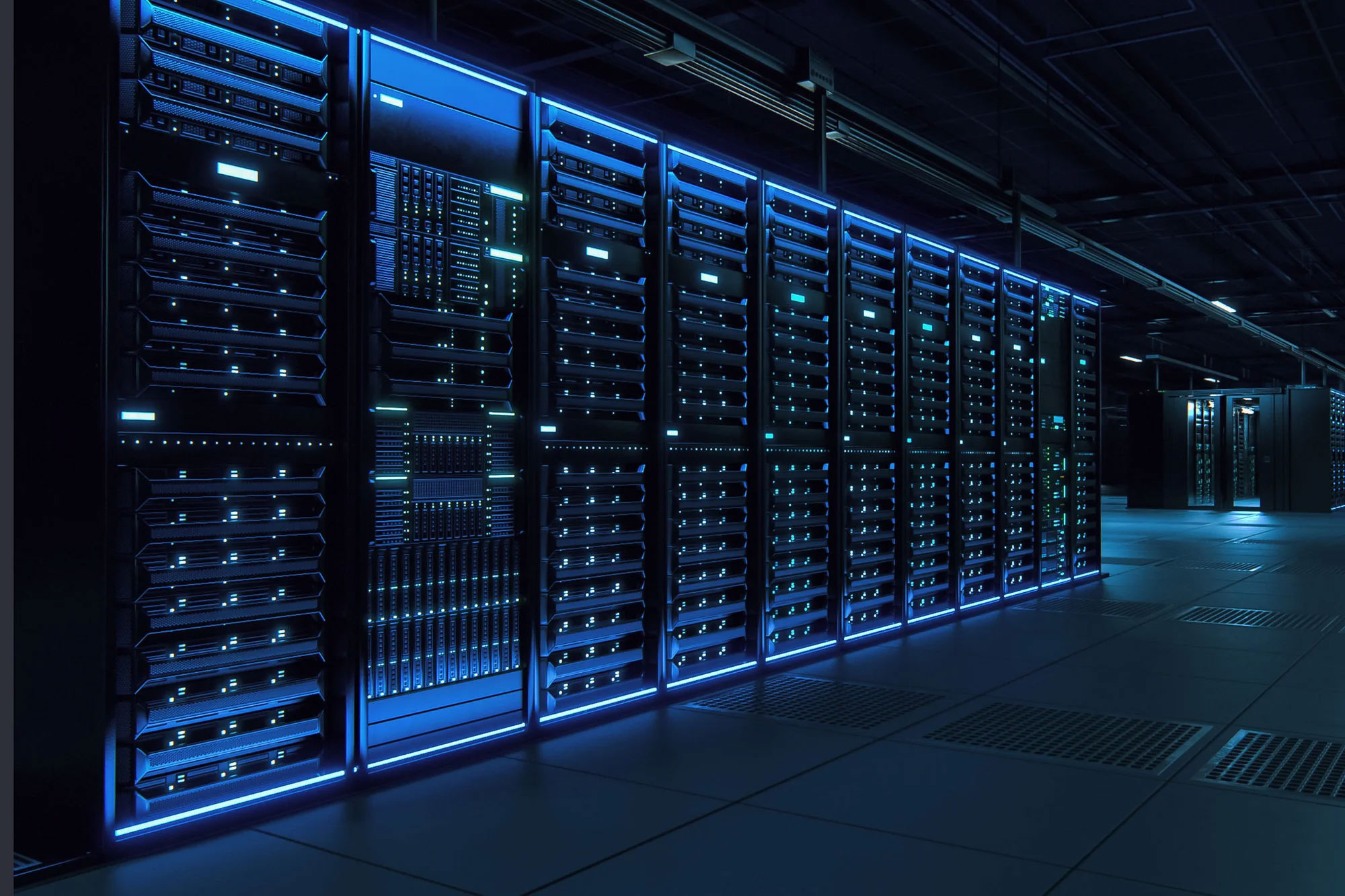 An image of a modern data technology center with a row of server racks inside a dark facility