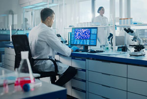 Scientists working on computer developing drugs in a lab