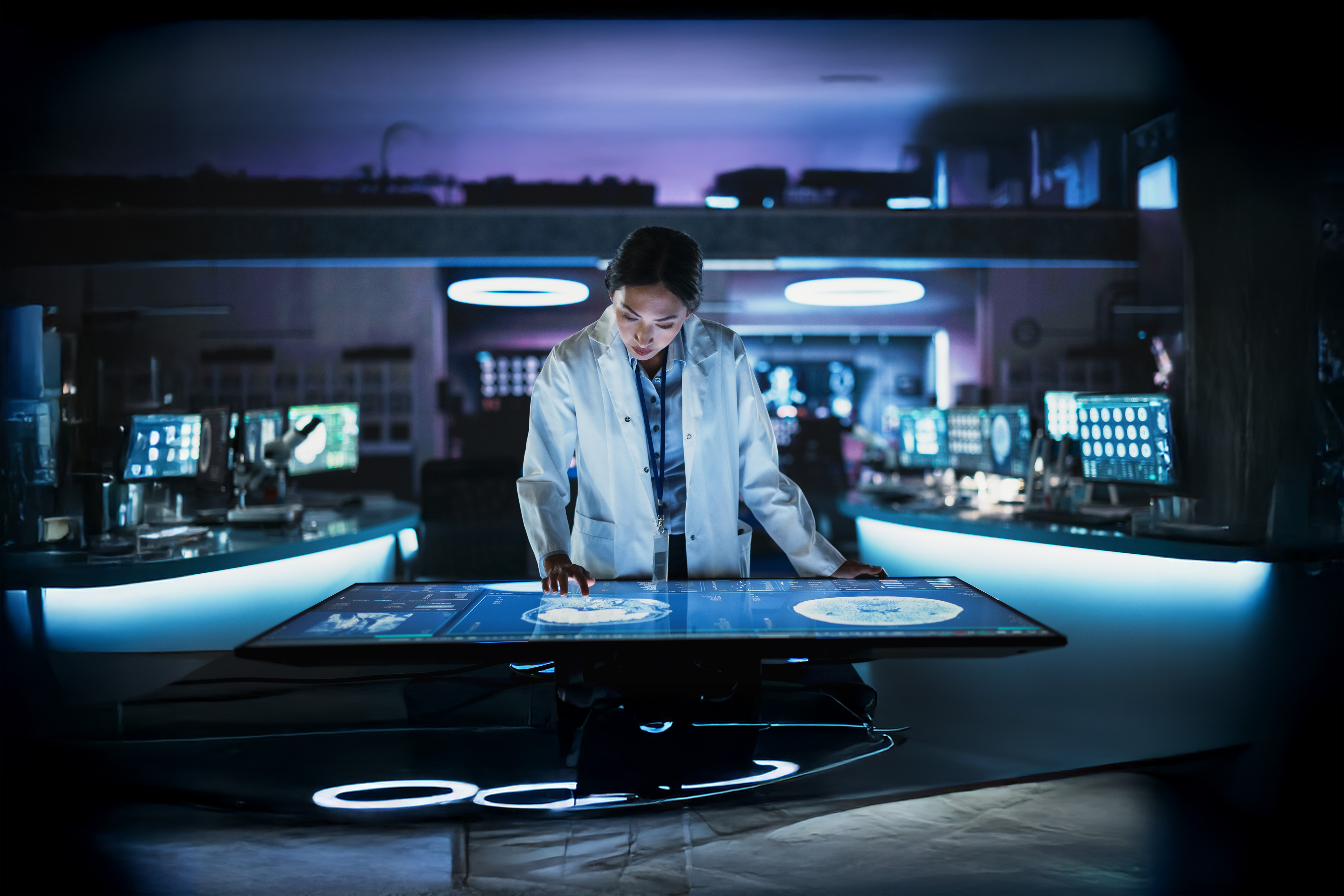 Female neuroscientist using interactive touch screen table