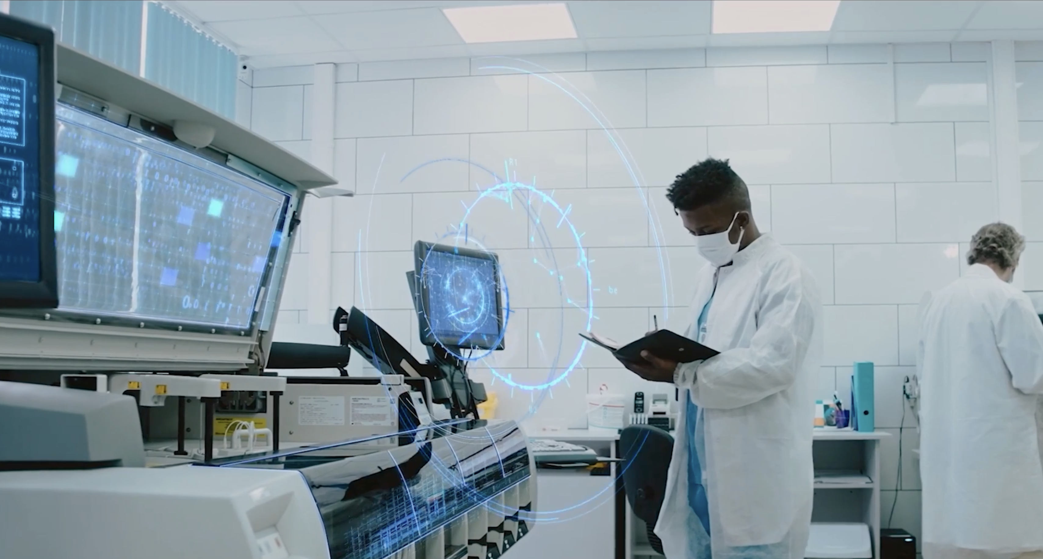 A scientist in a face mask taking notes while conducting a test in a medical laboratory