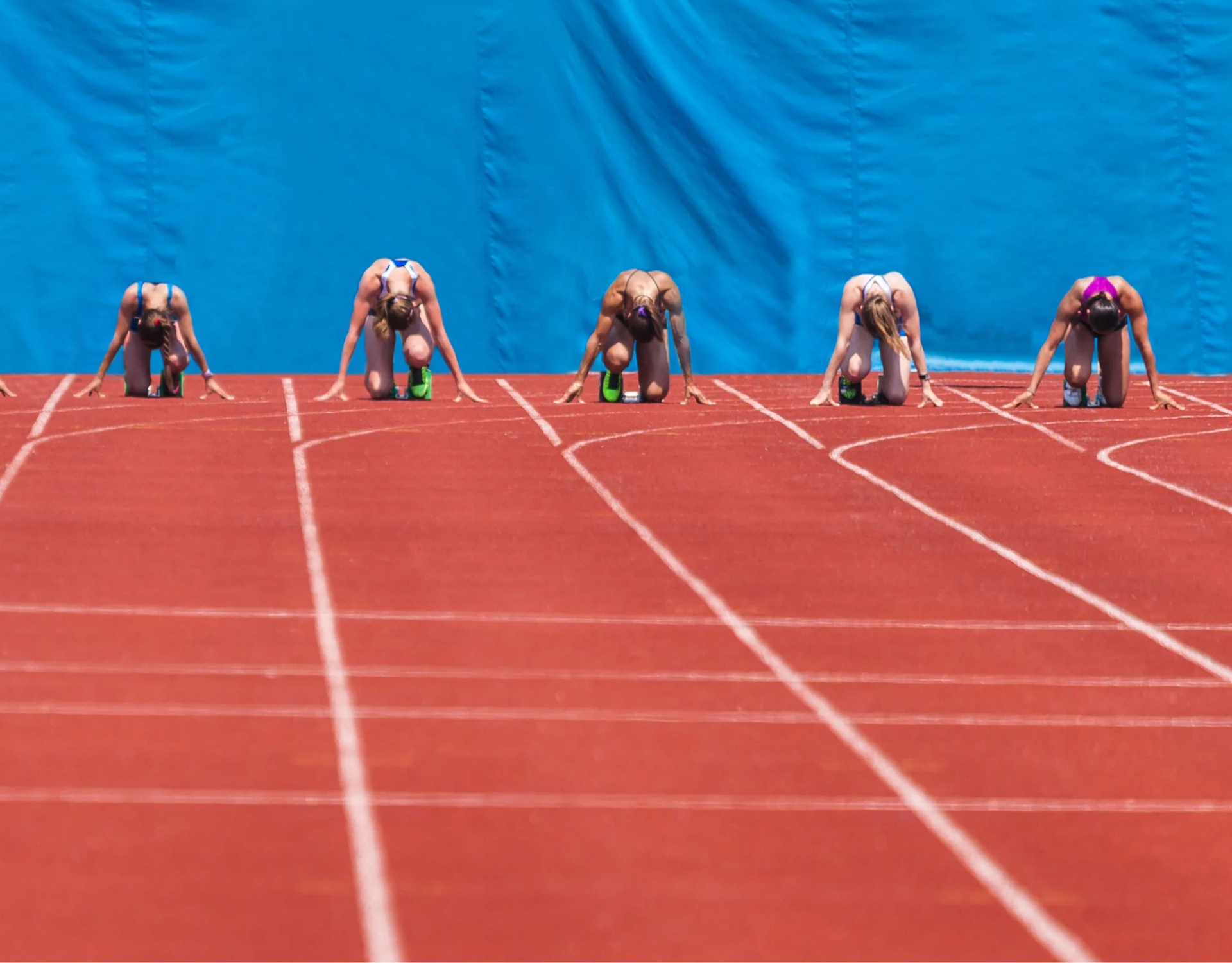 Image of relay racers preparing to begin the race on a track