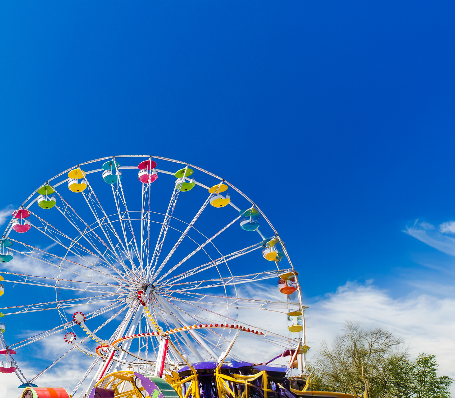 Sky view of an amusement park with a ferris wheel in the foreground