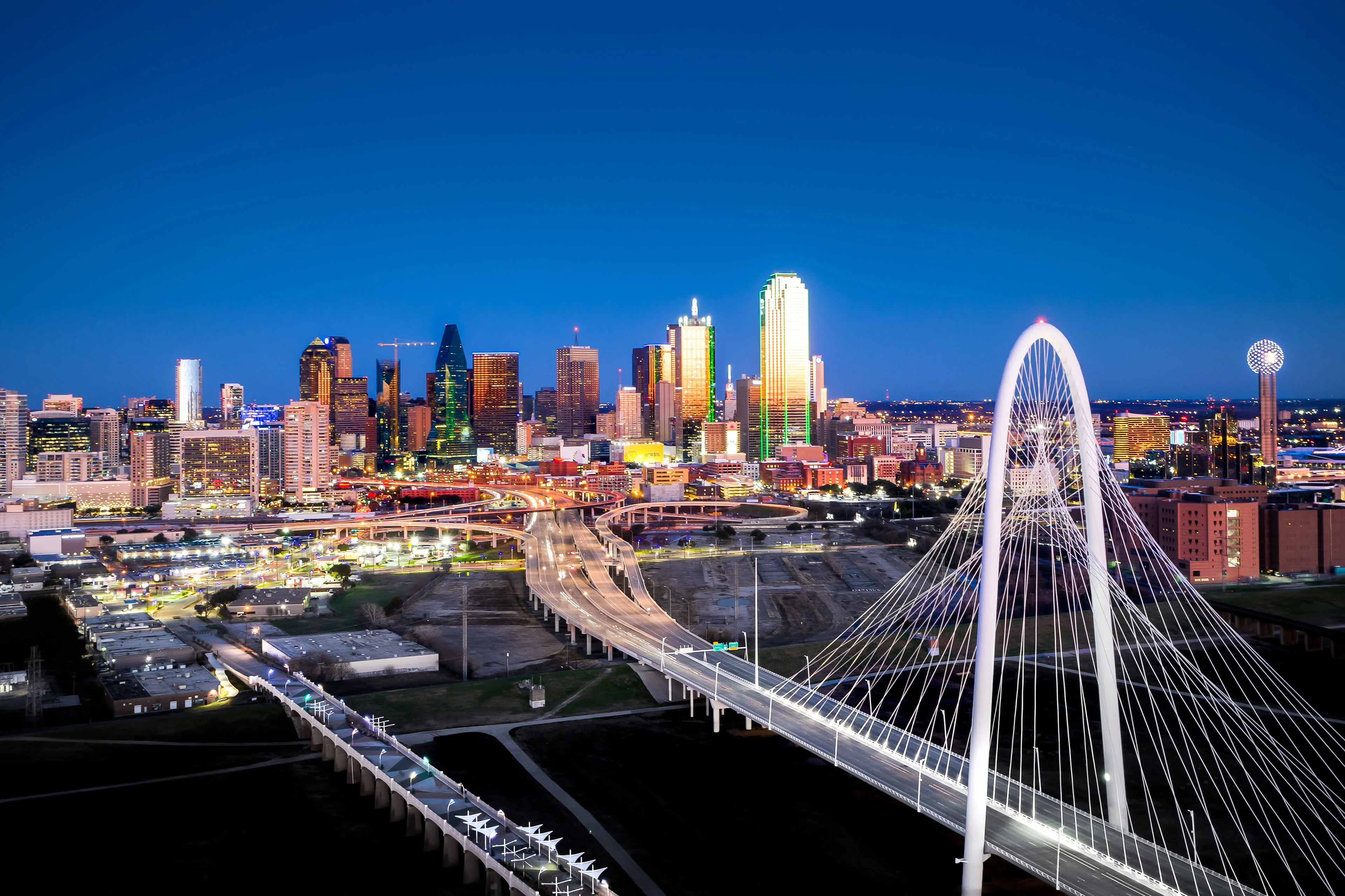 A shot from the sky overlooking the Margaret Hunt Hill bridge and downtown Dallas, USA