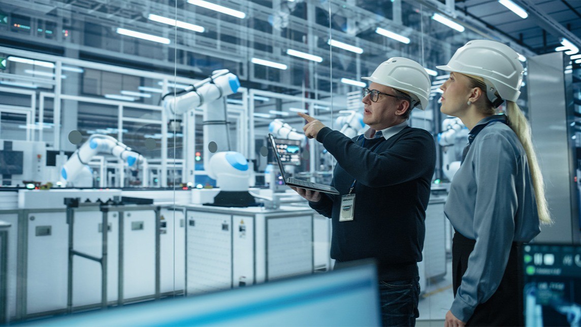 Lauren Schmeer smiling at a table with a cup of coffee in her hand