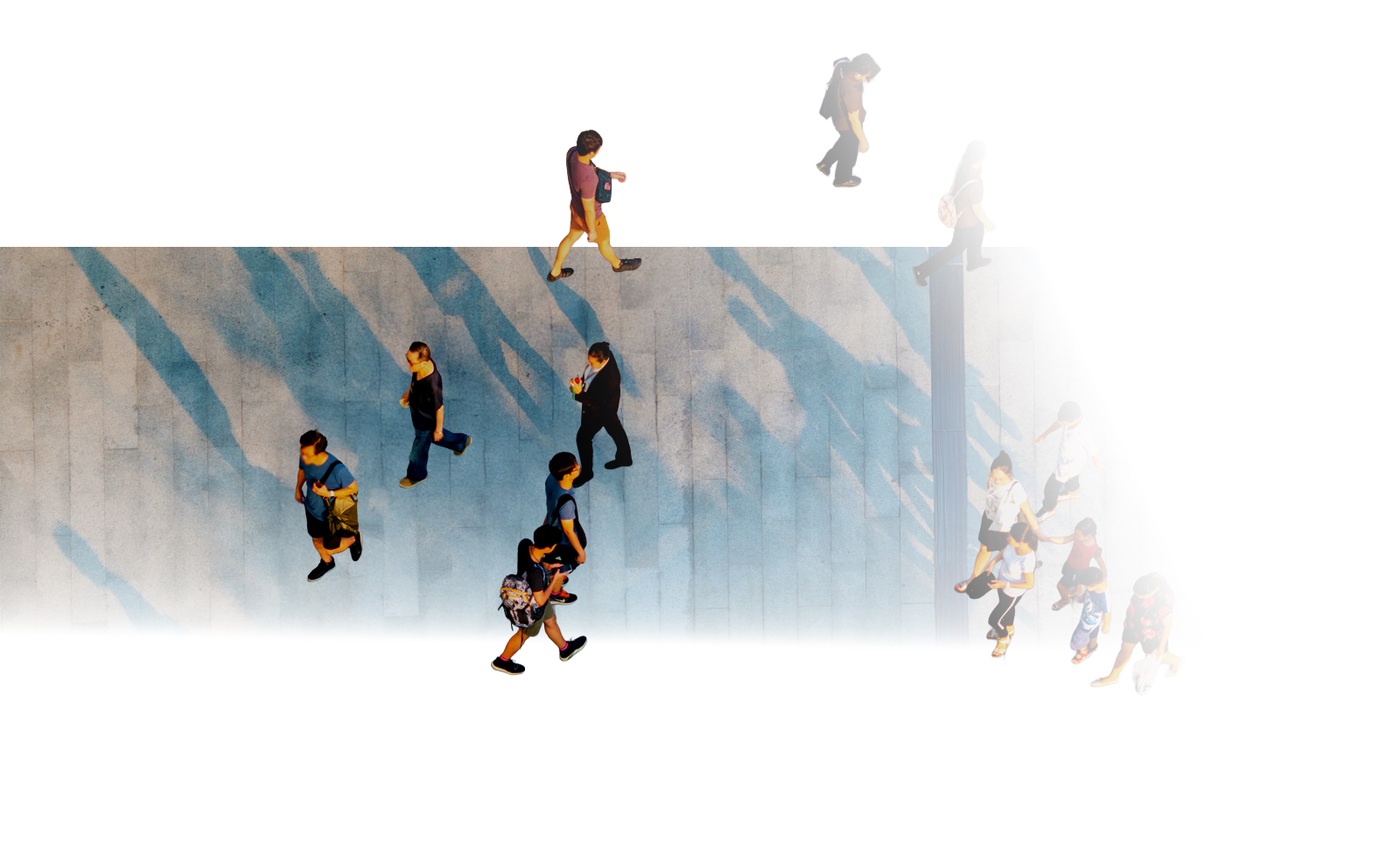 Image looking down towards people waling across a brick paved courtyard