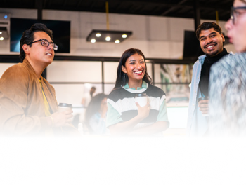 team of people huddled in a circle chatting in EY Studio+
