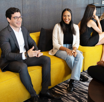 Image of EY colleagues hanging out on common area sofa and having a discussion