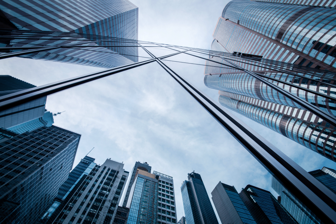 Image looking up towards tall high-rise buildings on a cloudy day