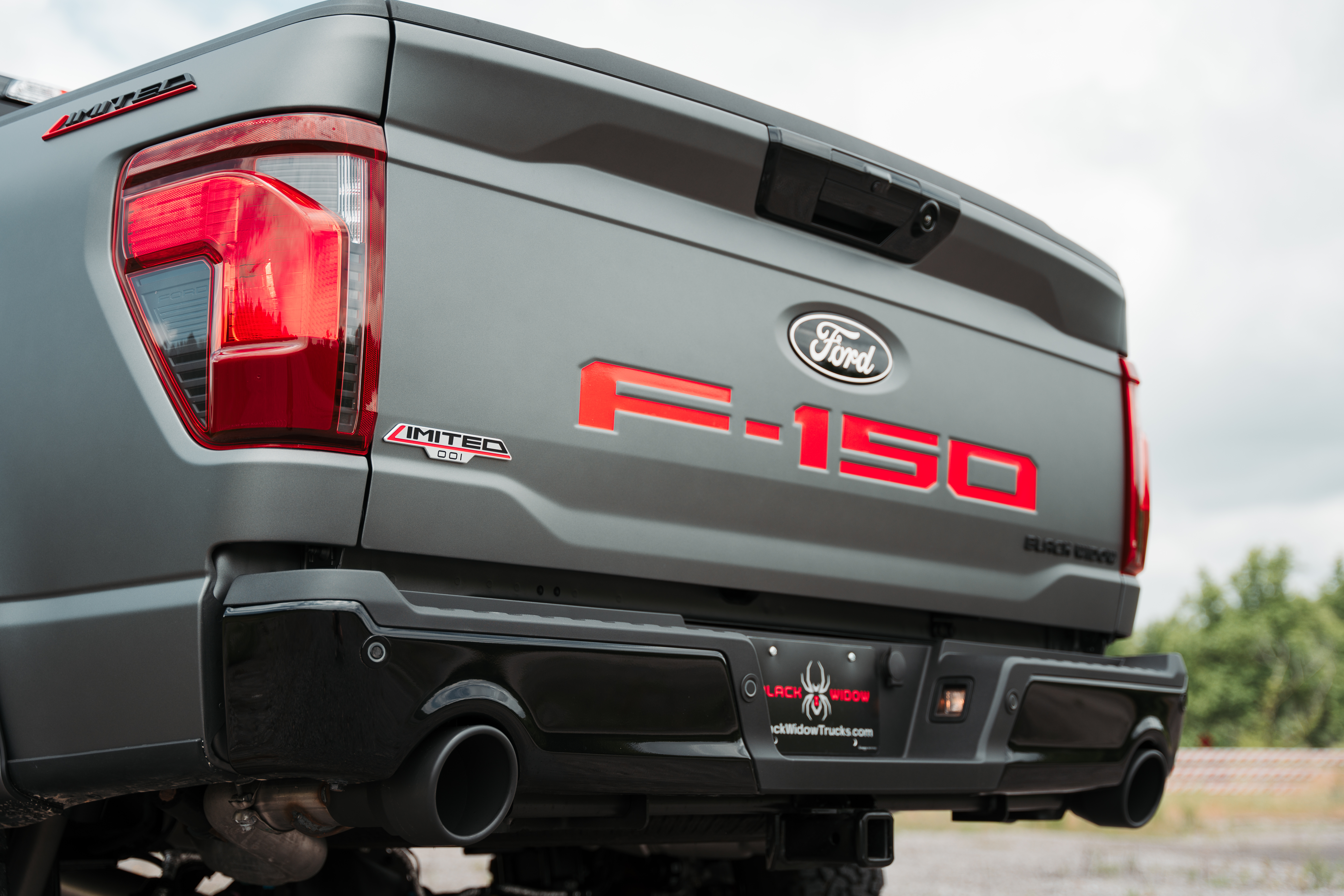 dual performance exhaust with black powder coated tips on a  black widow limited ford f150 lifted truck