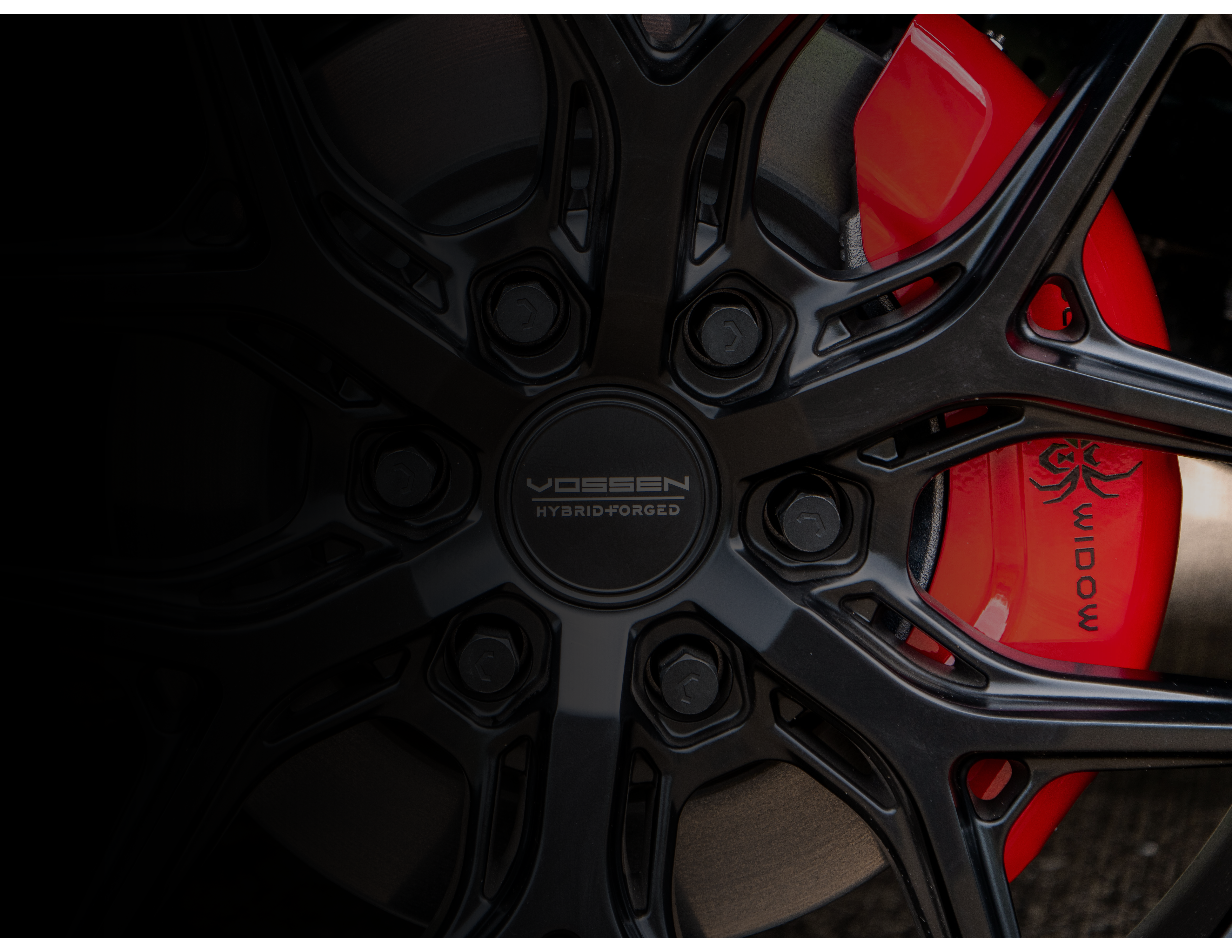 black matte Black widow truck wheel with offroad tire. red caliper cover with black widow spider logo