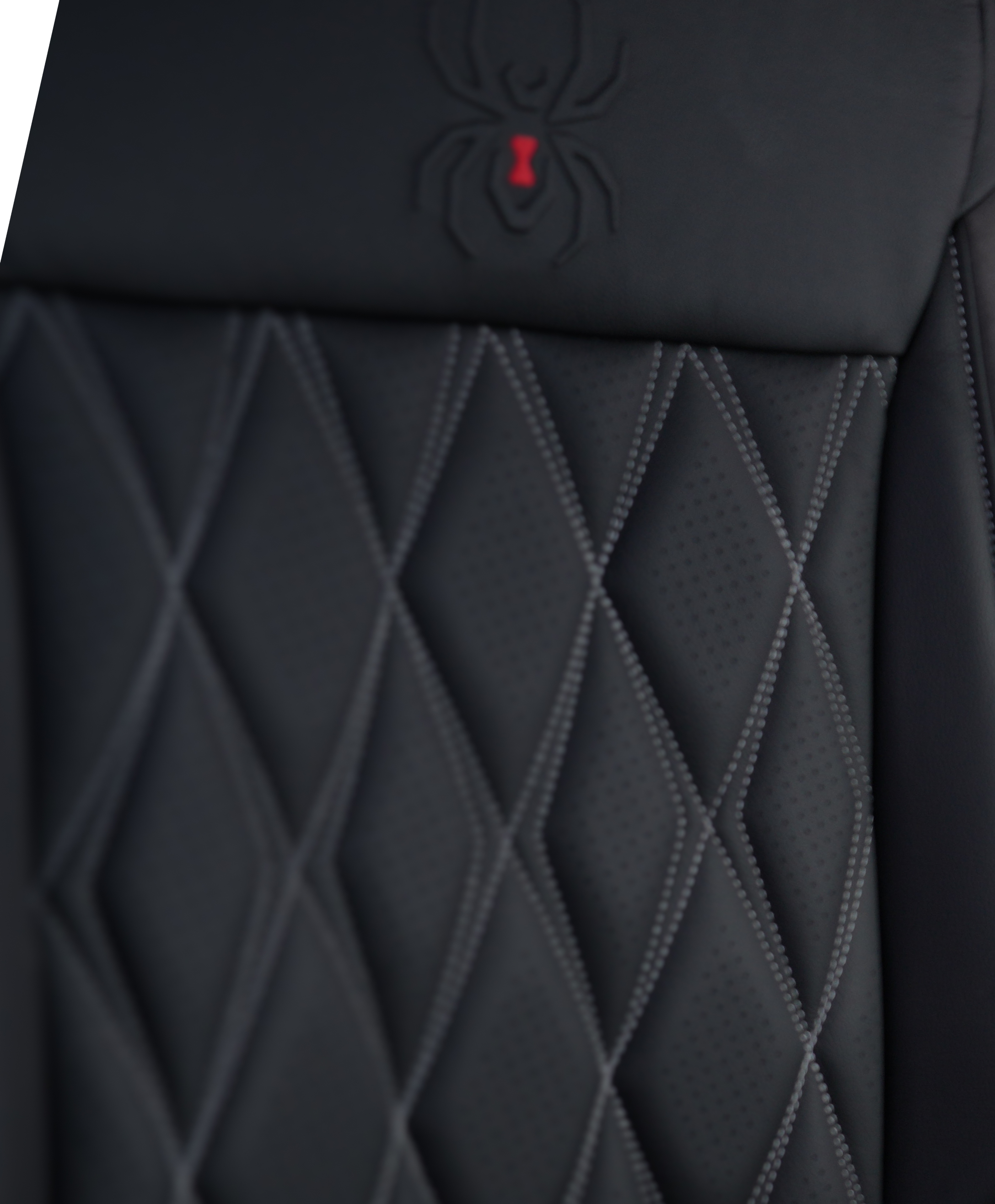 close up texture of the diamond pattern stitched perforated leather upholstery on the seats of a black widow lifted truck
