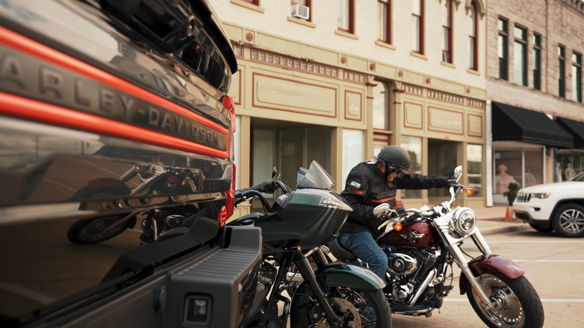 black lifted Harley-Davidson tailgate next to two motorcycles