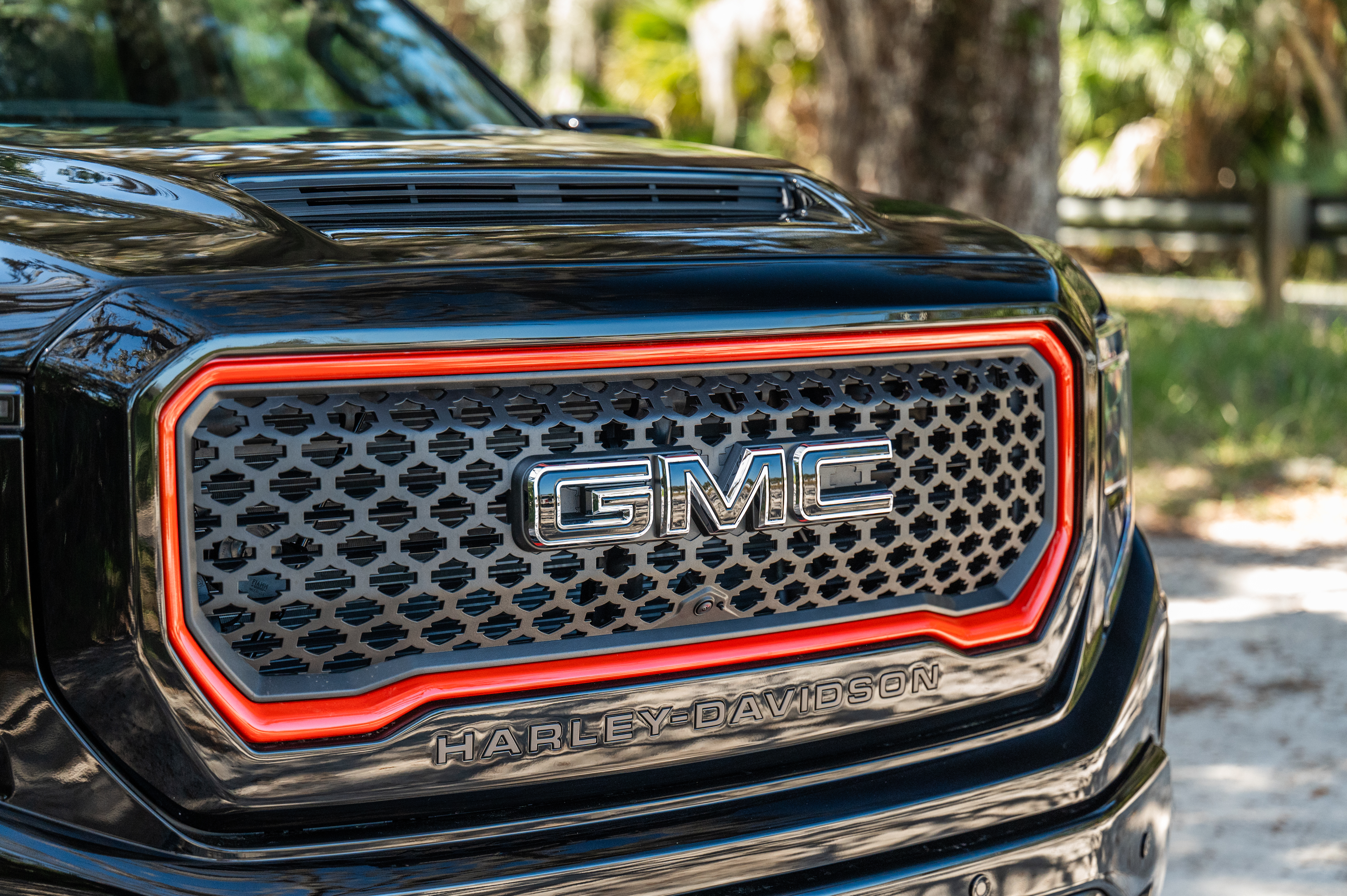 Complete Grille Replacement with orange Painted Accents on GMC Sierra 1500 Harley-davidson trucks