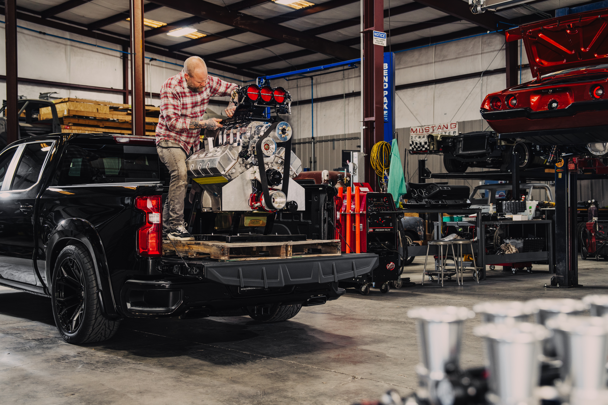 Lifted Chevrolet Silverado towing a wakeboard boat.